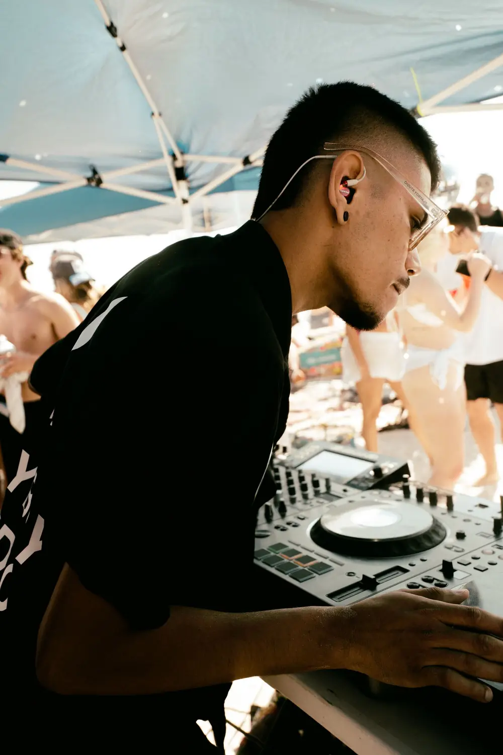 DJ mixing music at a beach party (illustrative stock photo)