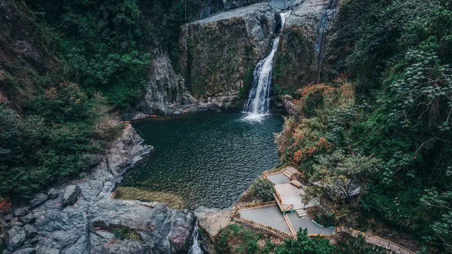 Aerial view of a waterfall and forest pool in Jarabacoa